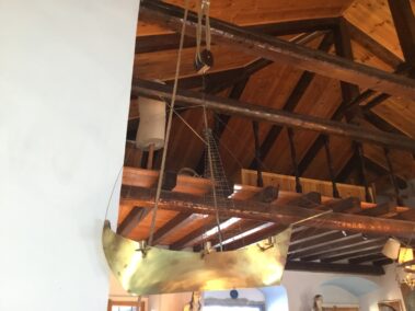 The boat shaped candelabra hanging from the ceiling